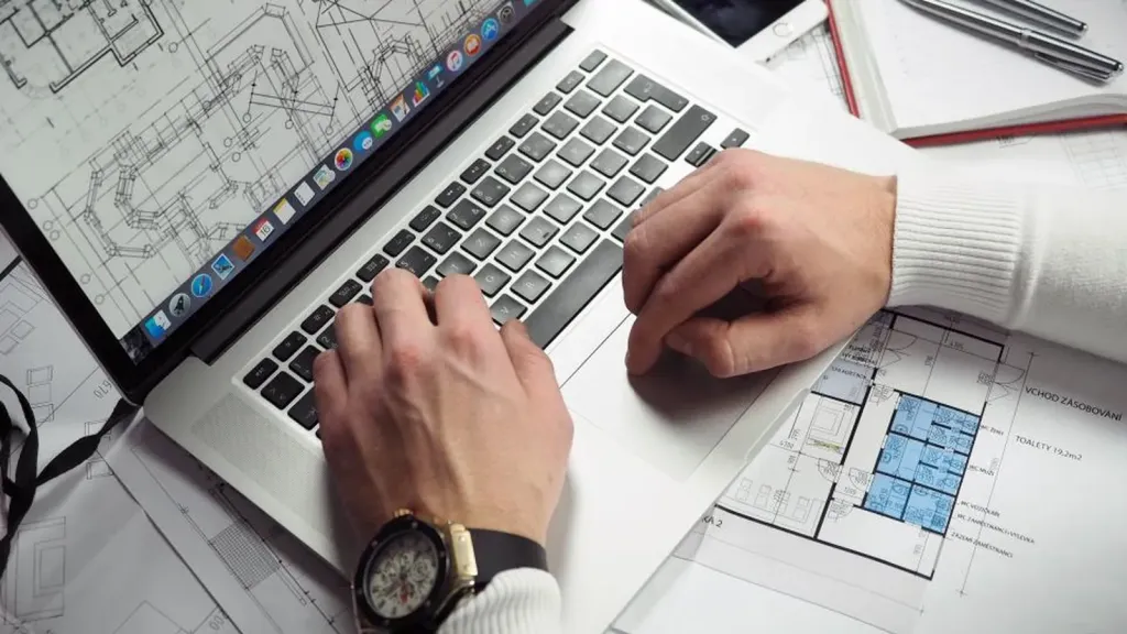 Notebook ledger, calculator and coins on a small business desk used to track cash flow