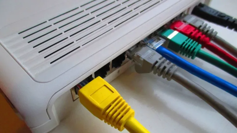 Home router with colourful network cables plugged into the back